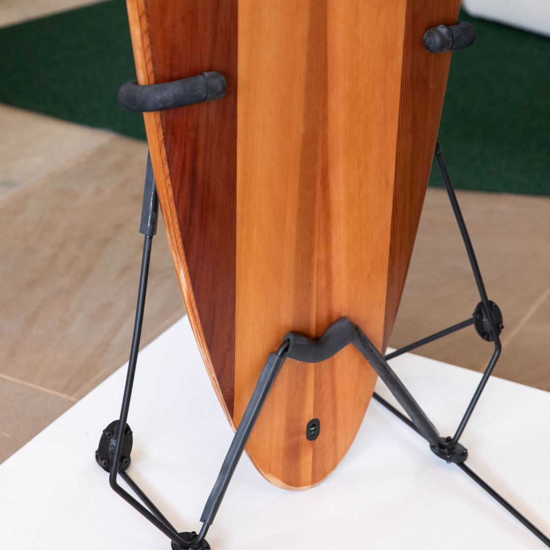 A close up of the base of the surfboard illustrating the timber grains and rounded base