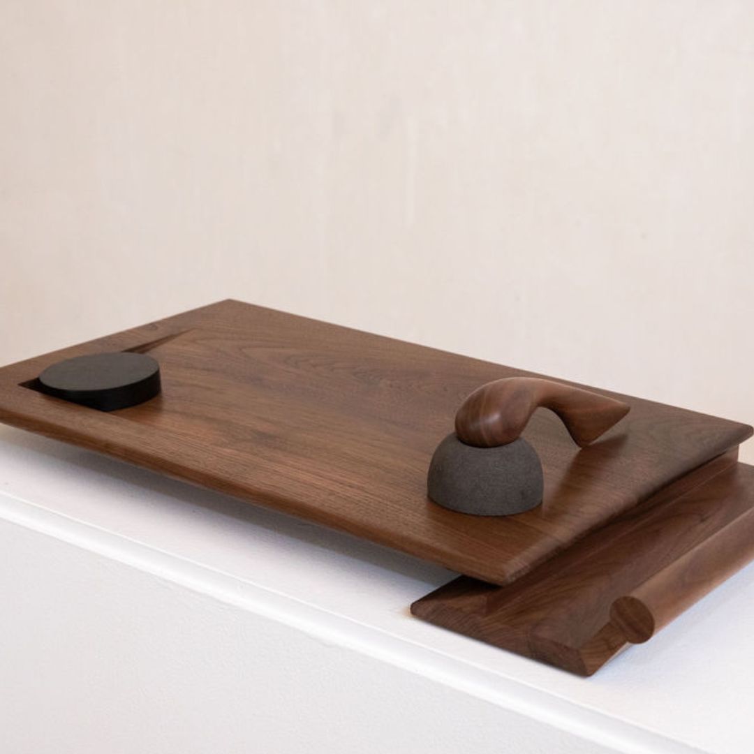 A walnut-wood board with a walnut-wood knife