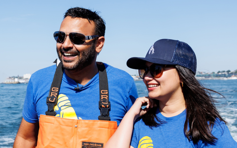 An image of two of our SF Bay and Denver family members on a Lobster Boat in Maine, smiling.