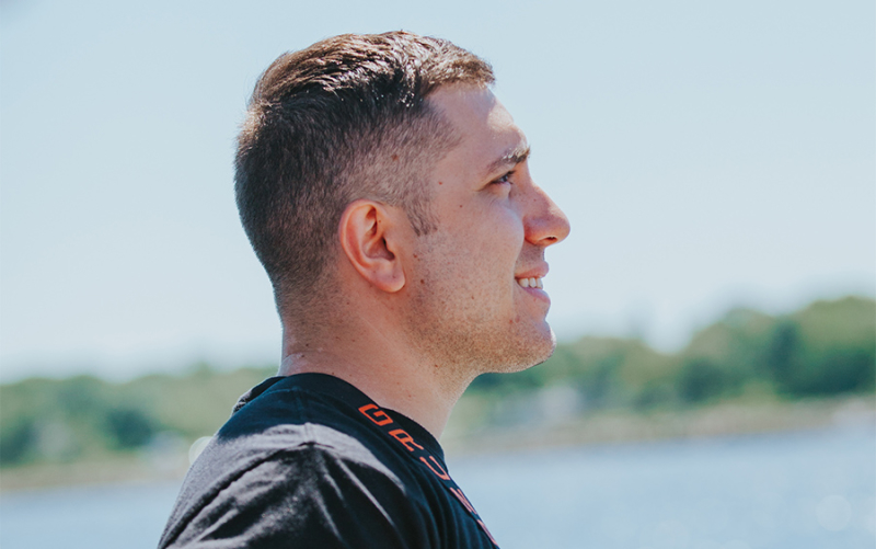 A close-up photo of one of our Cousins Maine Lobster Trenton and Philadelphia franchise owners staring out at the water in Maine.