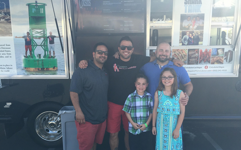 Our Vegas family members standing outside their food truck with Cousins Maine Lobster founder, Sabin.