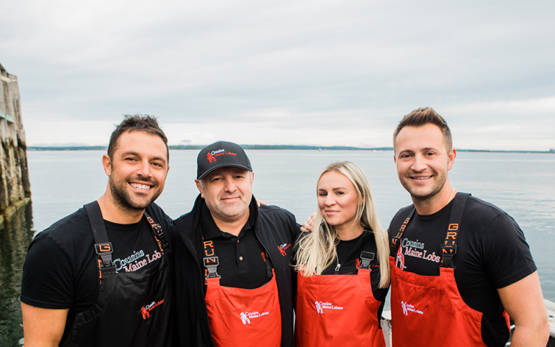 A photo of our Freehold, South Jersey and Jersey shore owners standing with Cousins Maine Lobster founders, Jim & Sabin.