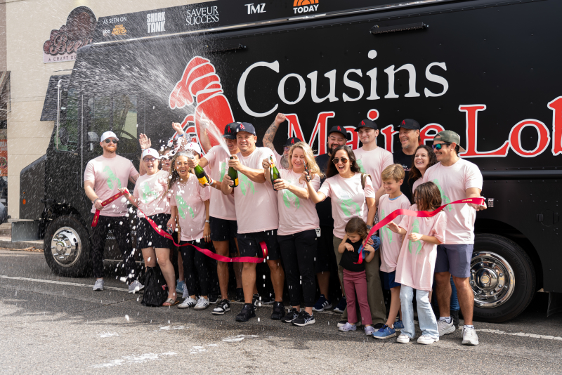 The Jacksonville family celebrates the grand opening of their truck with a ribbon cutting and champagne spray!