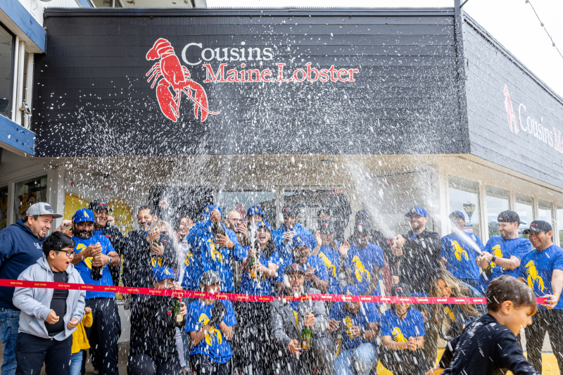 The San Francisco Cousins Maine Lobster family celebrates the Grand Opening of the Pier 41 Restaurant with the traditional ribbon cutting and Champagne showers