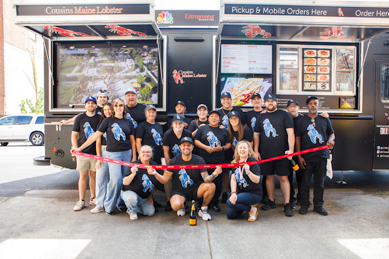 Our Kentucky Family poses in front of their truck at their Grand Opening!