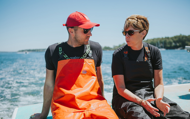 A photo of our Columbus franchisee, sitting with Cousins Maine Lobster founder, Jim, on the back of a lobster boat.