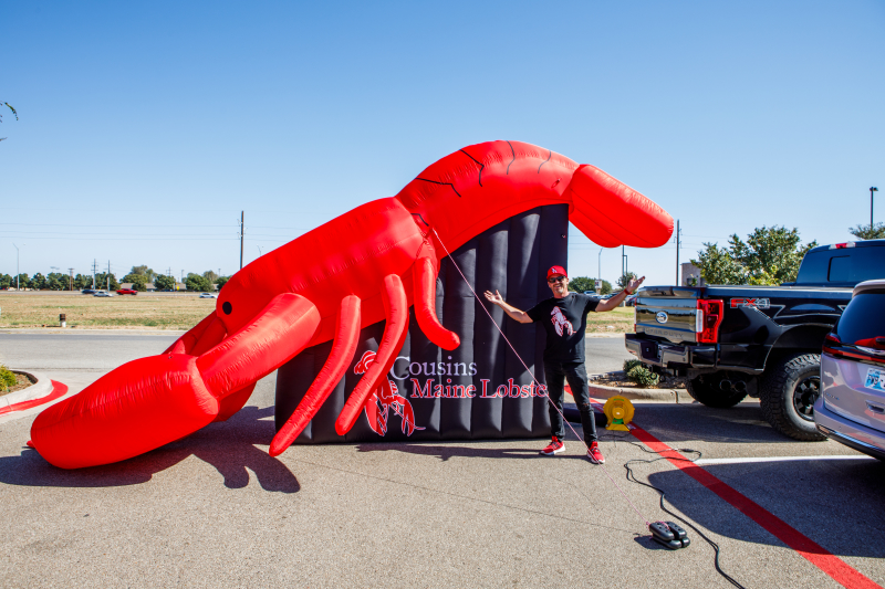 Cousin Chris poses proudly in front of his giant inflatable Cousins Maine Lobster! 