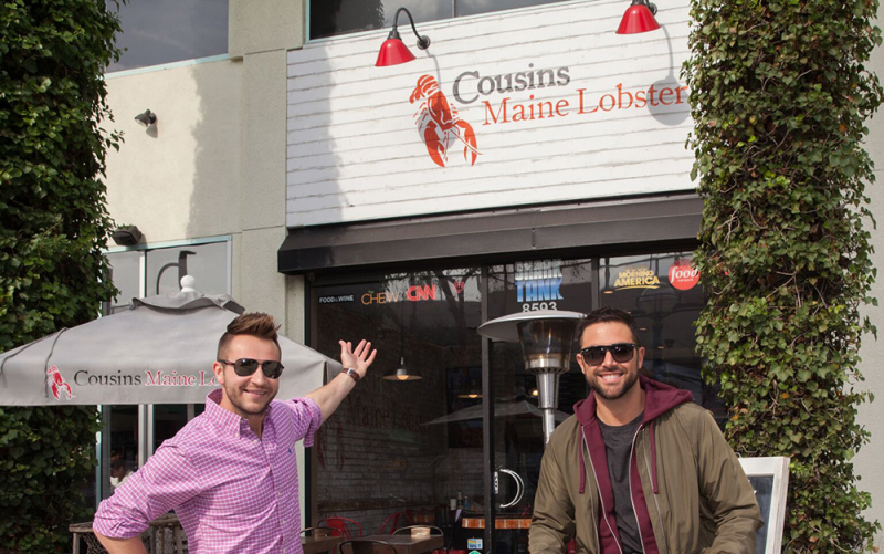 Cousins Maine Lobster founders, Jim & Sabin, stand outside the flagship Cousins Maine Lobster restaurant, located in West Hollywood, CA.