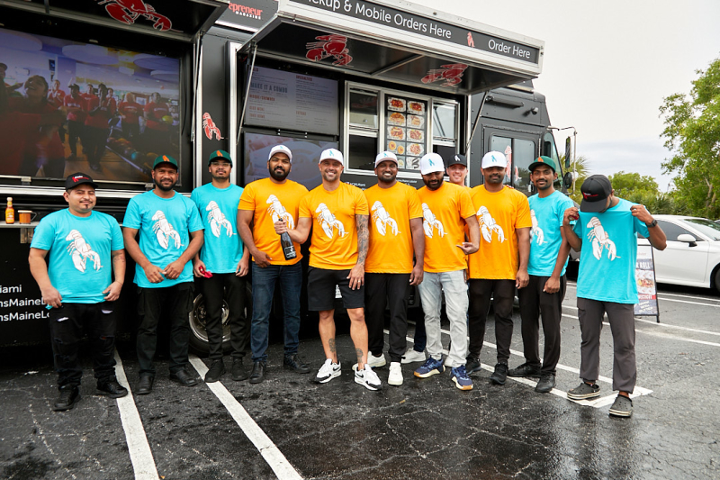 The Cousins Maine Lobster Miami Family poses with Cousin Sabin to celebrate the re-opening of the Miami Truck.