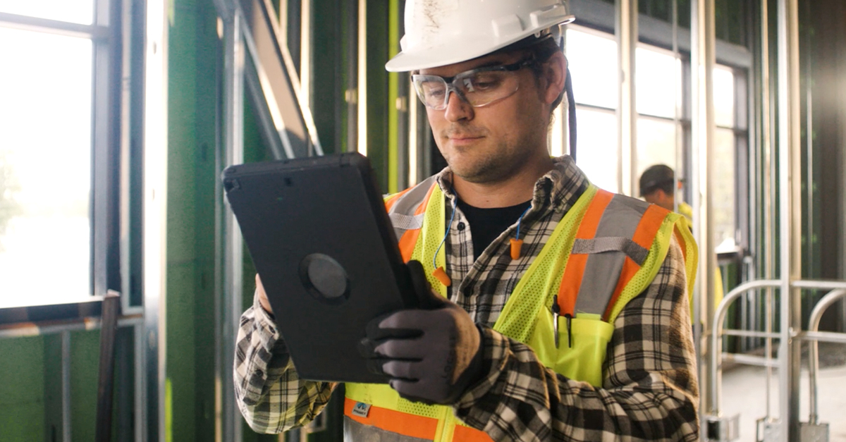 A construction worker uses Fieldwire on the jobsite keep track of tasks and timelines