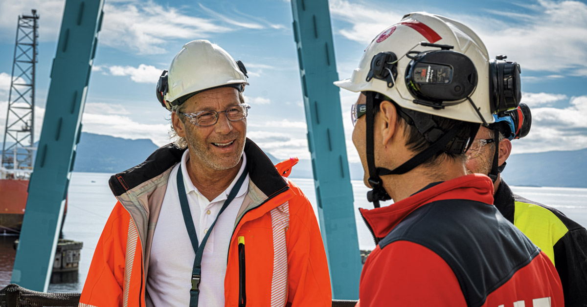 worker smiling talking to hilti rep field jobsite