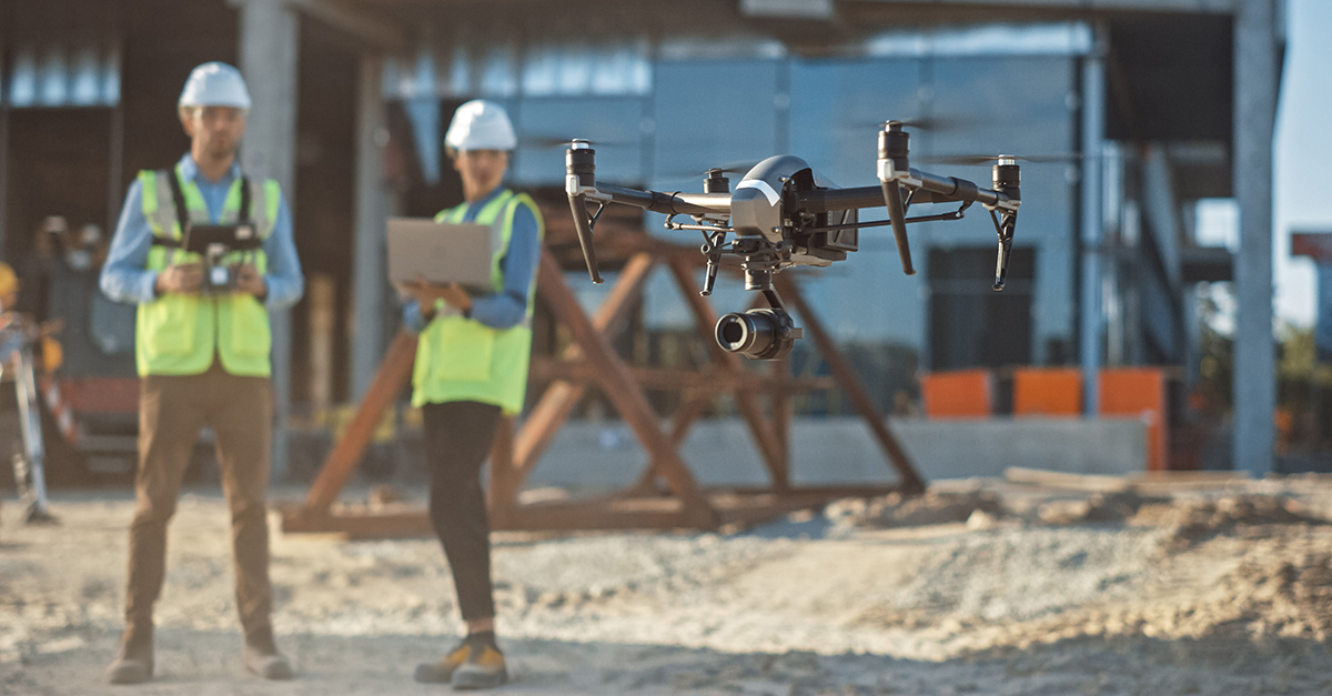 Construction workers operate a drone on a jobsite