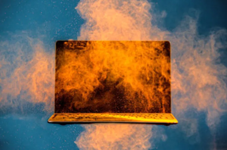 Image with a closed laptop with orange sand Image with a closed laptop with orange sand