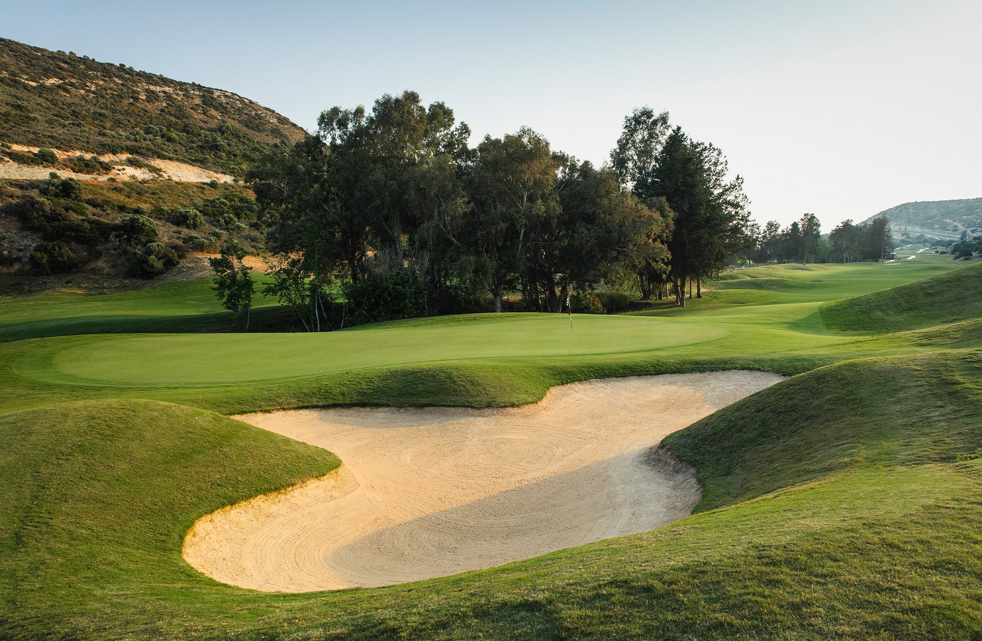 green på secret valley golf club omgitt av bunker og kupert fairway
