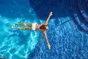 girl swimming in crystal clear mineral pool 