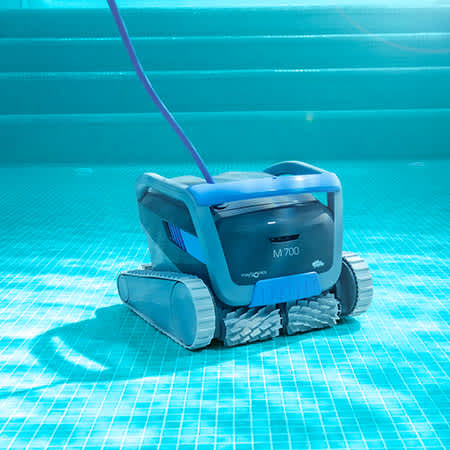 Maytronics Dolphin M 700 underwater cleaning the pool floor