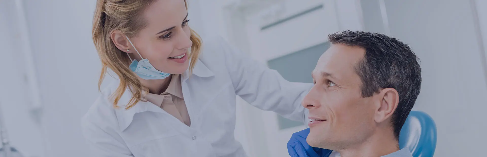 A dentist explains an image of a dental imprint to his patient, while she is smiling and confident because she knew what to expect at the dentist. 