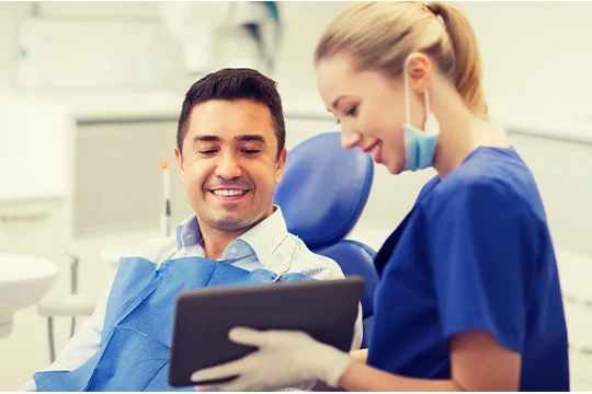 A dentist explains the ingredients of Fixodent to her patient.