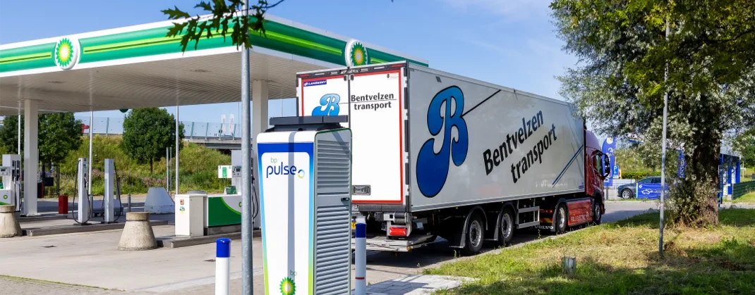 A large transport truck parked near a bp pulse charger.