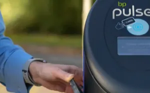 A hand holding a cell phone is scanning it against a bp pulse charger. 
