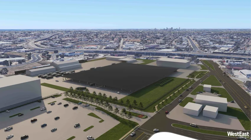 A solar energy area, in the middle of a town, with blue sky. 