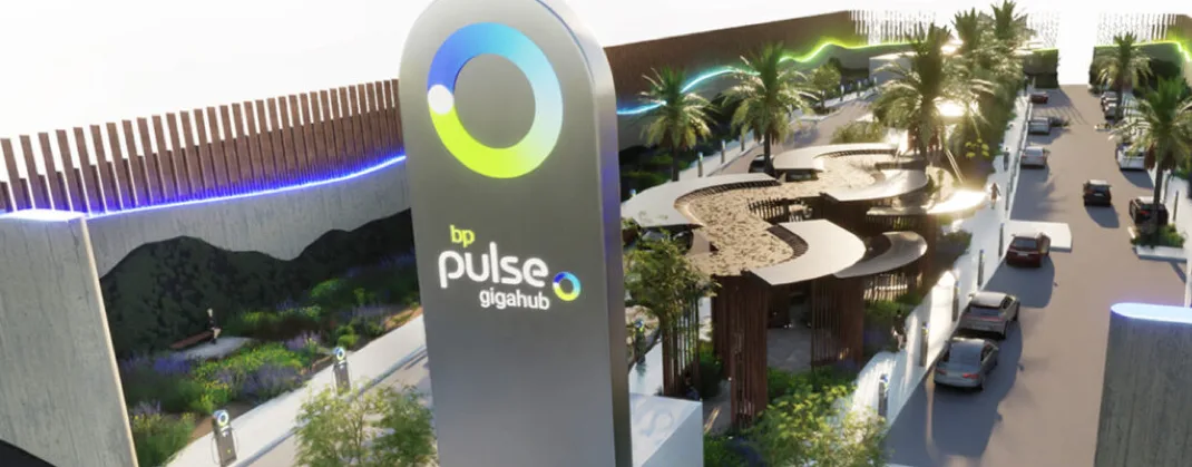 Gigahub™ site in a landscaped area, with some cars and palm trees on a street. 