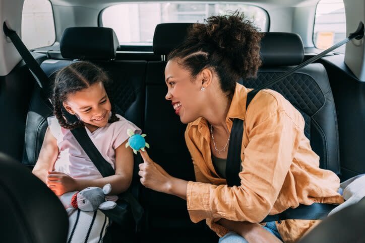 Women and small girl travelling in car