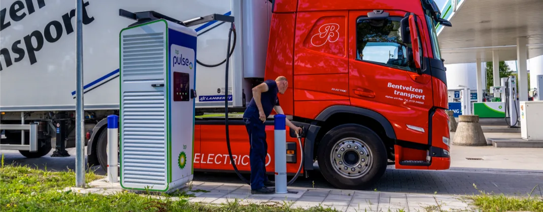 A man charging his large EV truck at a bp pulse charging station. 