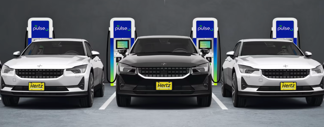Three EVs with 'Hertz' on the registration plate, parked in front of bp pulse chargers.