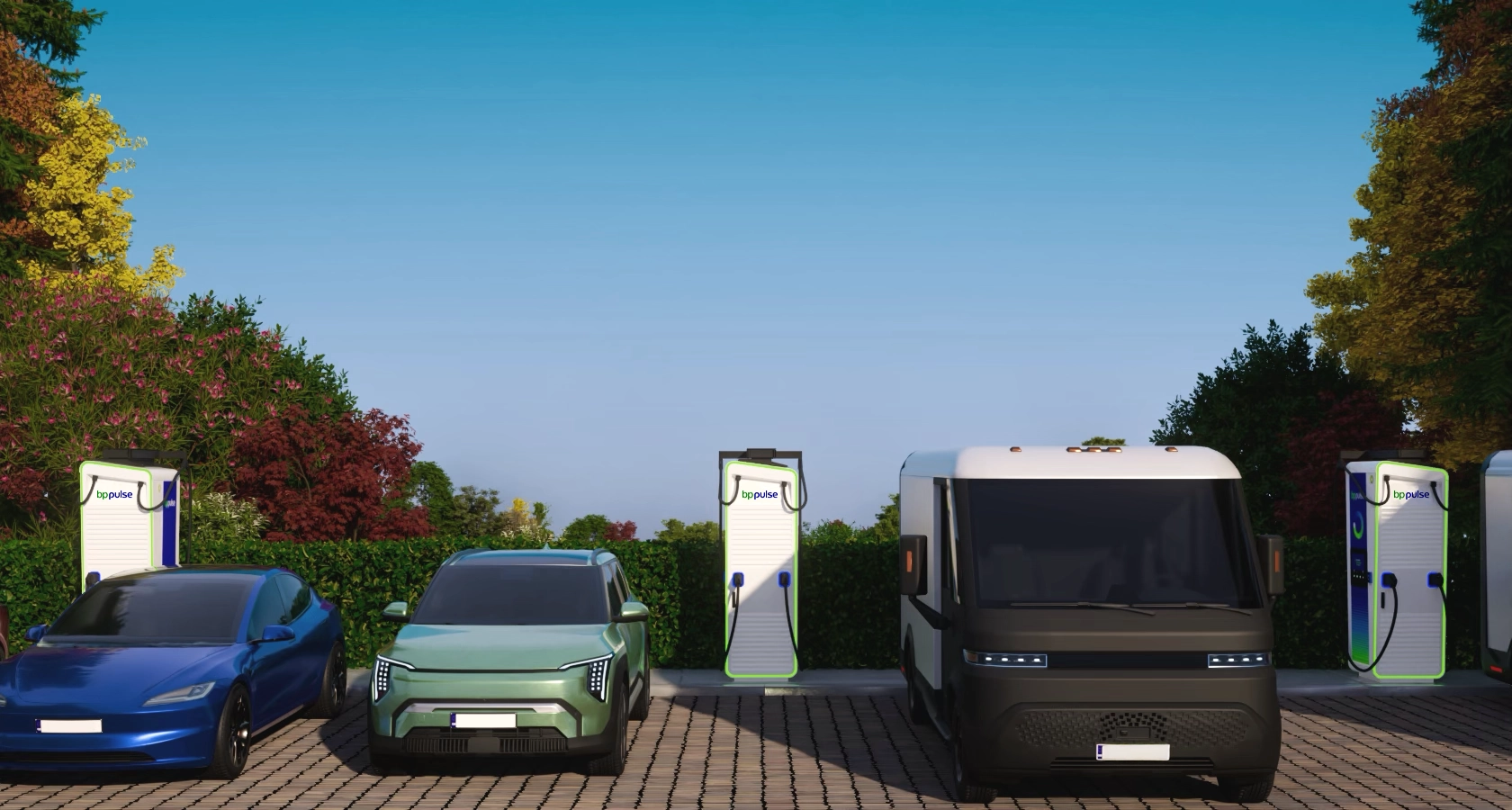 Three EVs parked side by side, charging at bp pulse chargers in a landscaped outdoor setting with greenery and trees in the background.
