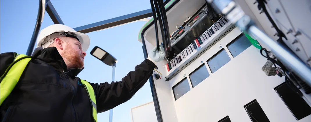 A technician inspecting an EV charger.