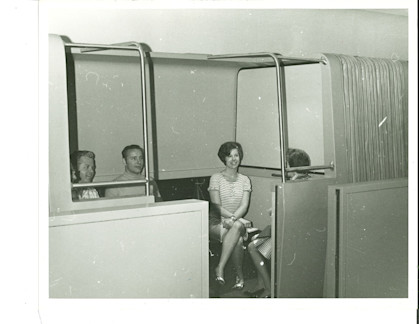 Passengers sit inside one of the original WEDway vehicles. Lightweight cars and minimal onboard machinery were central to a deliberately simple design engineered for reliability.