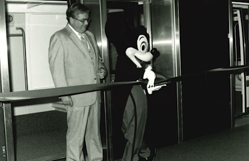 Mickey Mouse and Houston Mayor Jim McConn prepare to cut the ribbon for Houston’s WEDway PeopleMover. The opening made IAH the only airport in the world with a Disney-designed PeopleMover outside Disney property. 