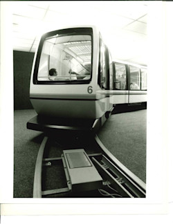 Train 6 sits above the guideway that made WEDway different. Linear induction motors built into the track propel the lightweight vehicles, leaving the cars without conventional onboard drive motors. 