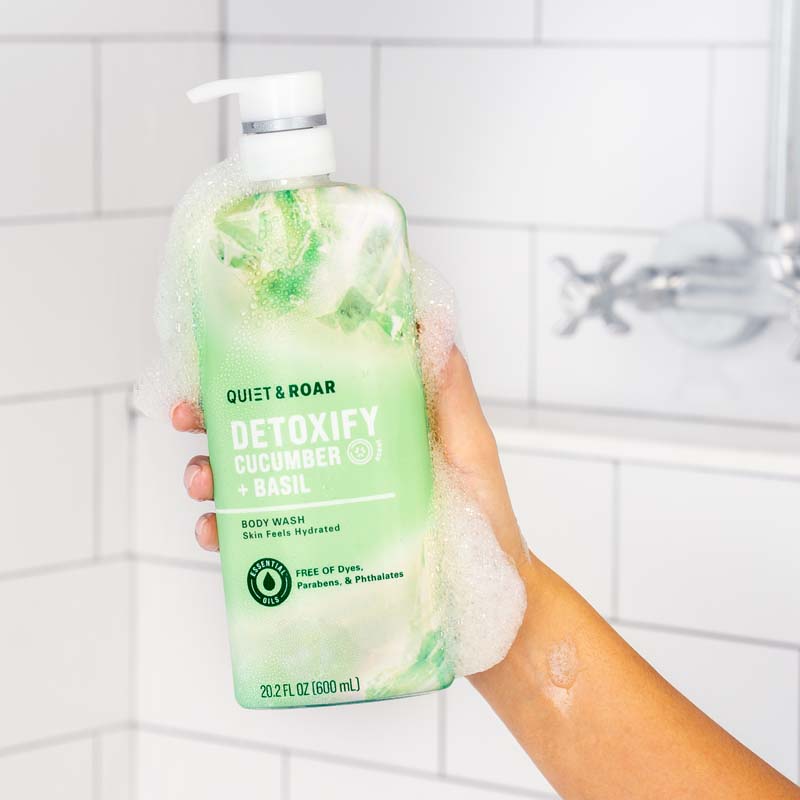 DETOXIFY CUCUMBER + BASIL BODY WASH in hand