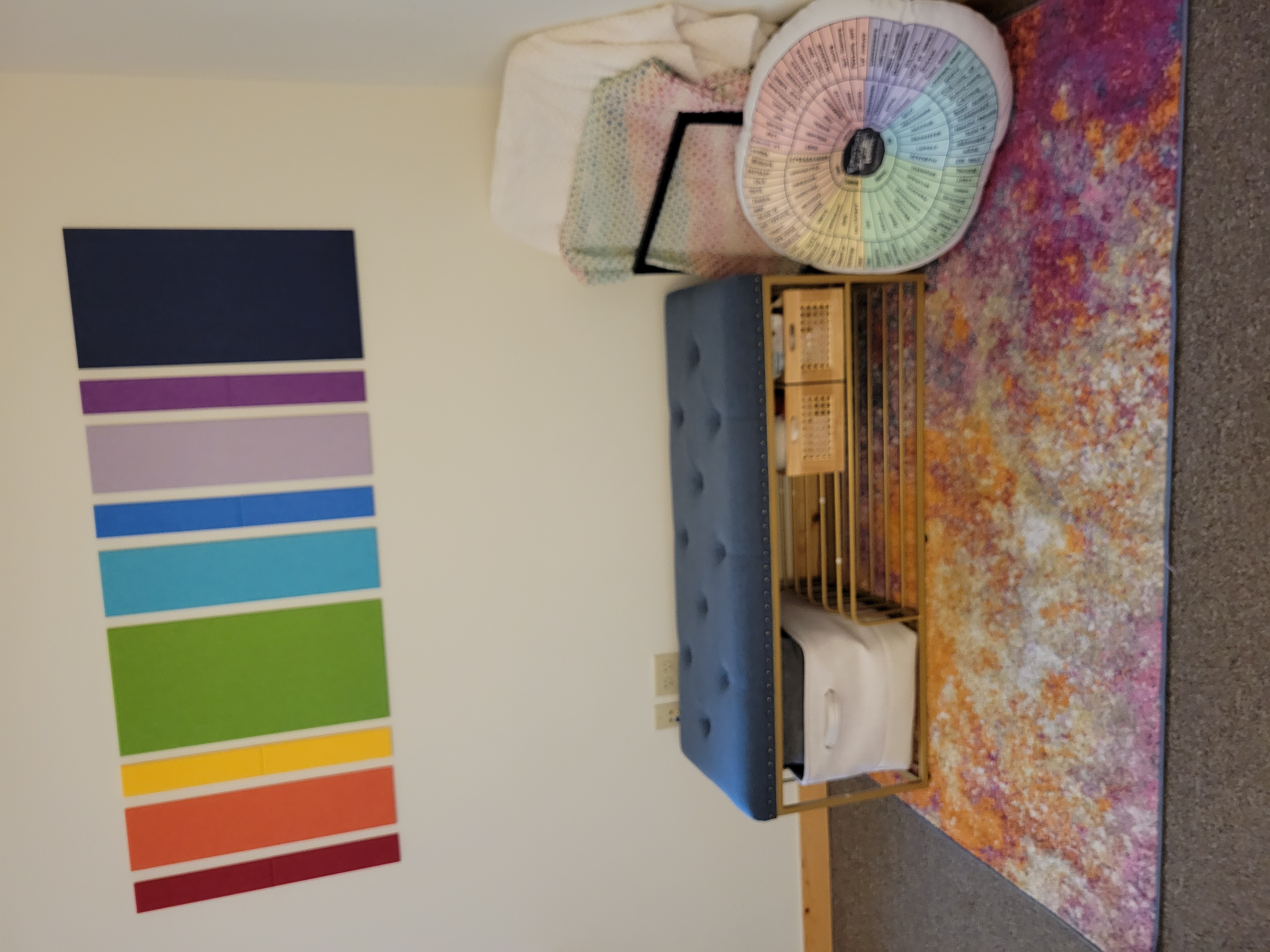 My entry bench with a rainbow pattern on the wall.
