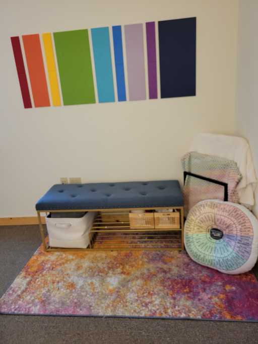 My entry bench with a rainbow pattern on the wall.