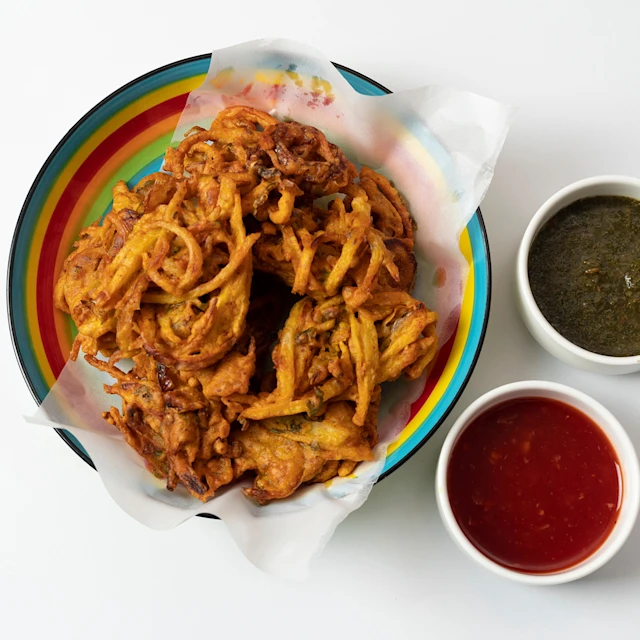 A colourful plate of Napa Cabbage & Sweet Potato Pakoras