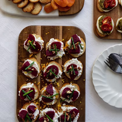 Image of Beet, Ricotta, Walnut & Orange Zest Canapés on a wooden board