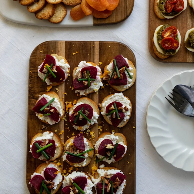 Image of Beet, Ricotta, Walnut & Orange Zest Canapés on a wooden board