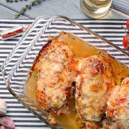 A casserole dish with baked chicken parmesan with spaghetti squash