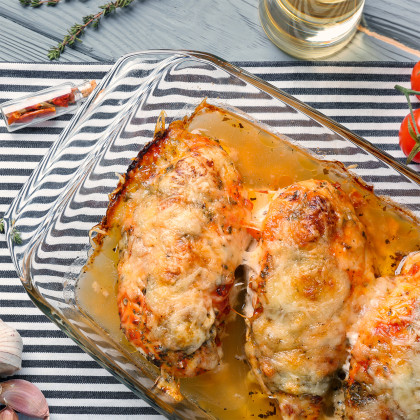 A casserole dish with baked chicken parmesan with spaghetti squash
