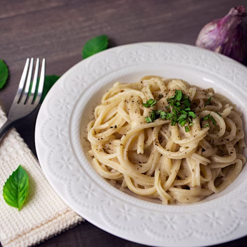 A plate of vegan alfredo sauce pasta