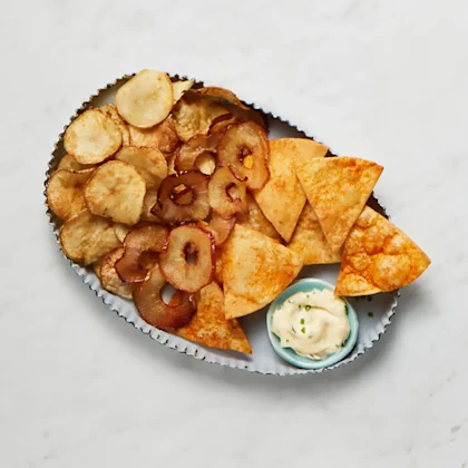 A platter of air fried apple tortilla and potato chips
