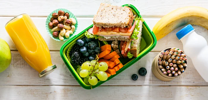 Image of a back to school kit - fruit, eggs, sandwich and milk
