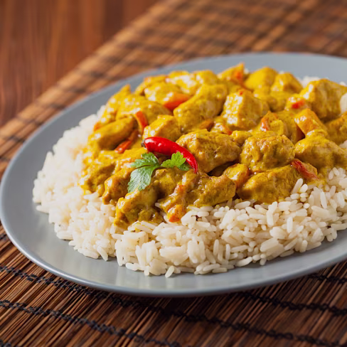 A plate of Cran-Apple Chicken Curry, on rice.