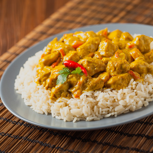 A plate of Cran-Apple Chicken Curry, on rice.