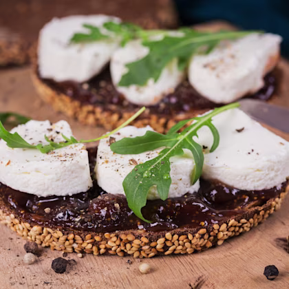 Fig Goats Cheese Crostini with arugula garnish