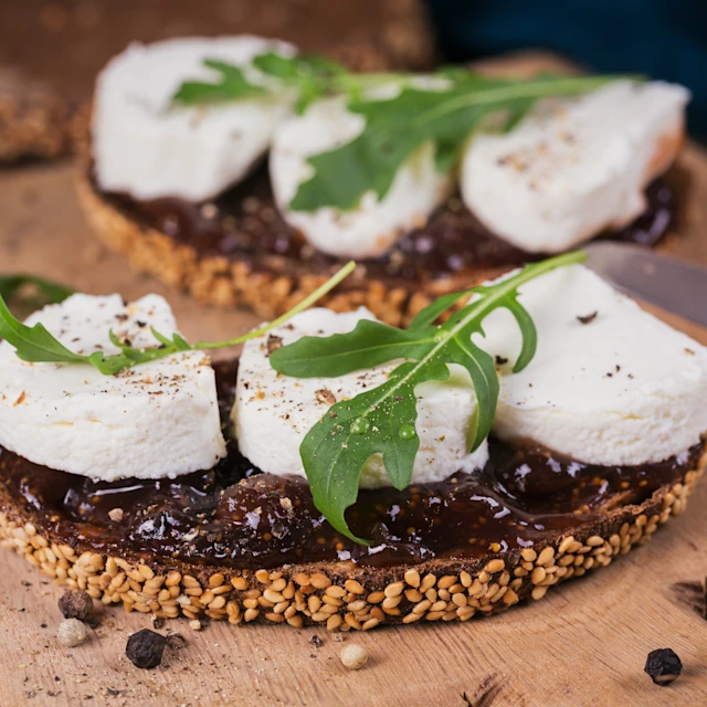 Fig Goats Cheese Crostini with arugula garnish