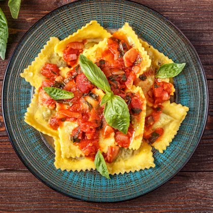 A bowl of Rana Ricotta & Spinach Ravioli with Carbonara-Inspired Sauce
